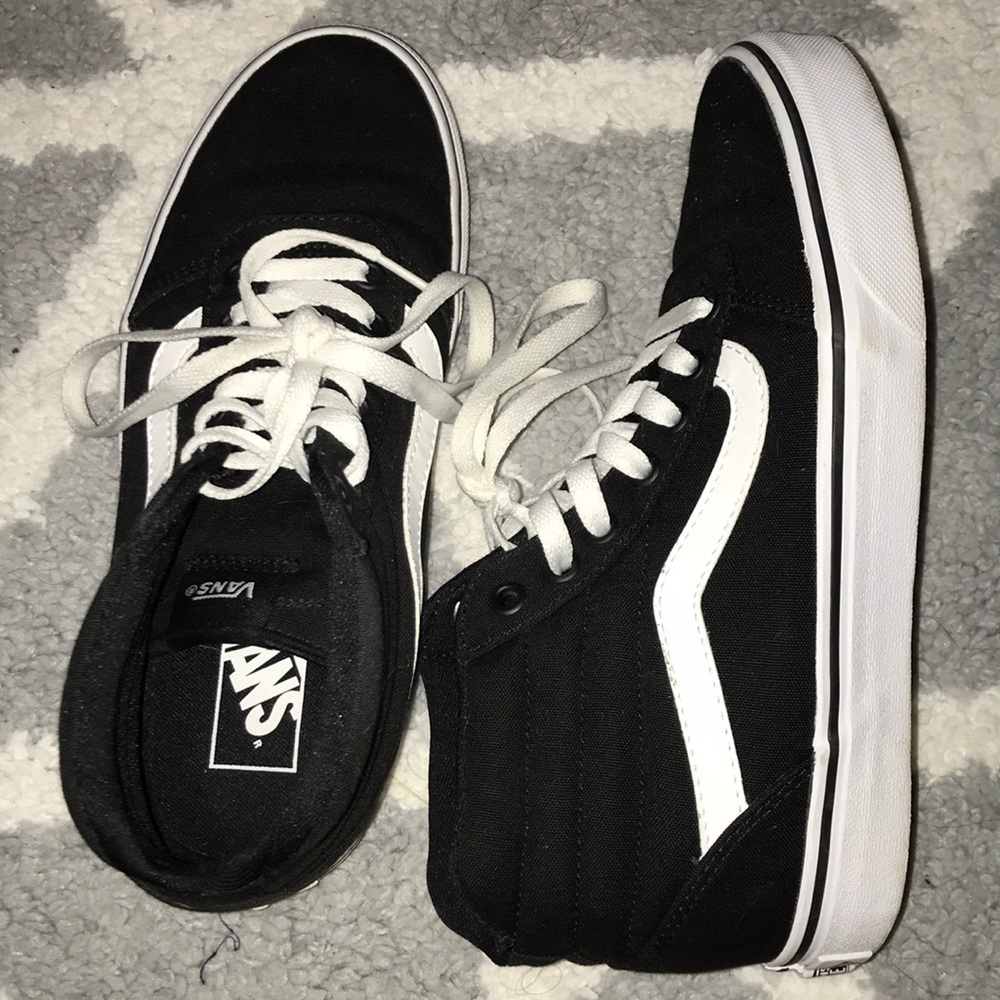 Black and white high top vans
